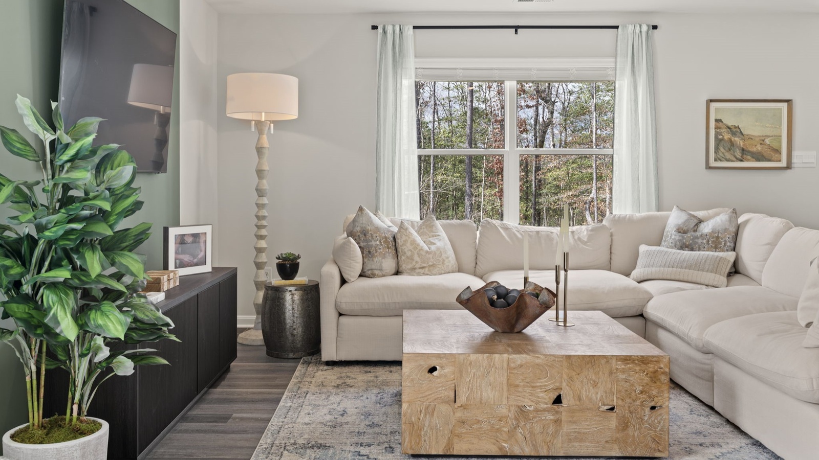 Living room designed by D.R. Horton showcases central access to the rear patio, kitchen and bedrooms