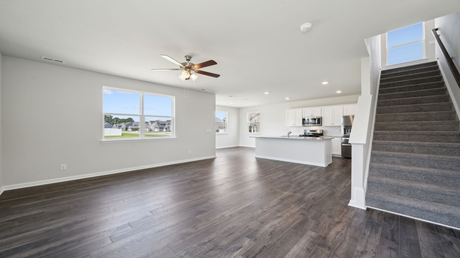 The kitchen features a large island with seating, pantry, New appliance suite, and Modern Design finishes near dining, living