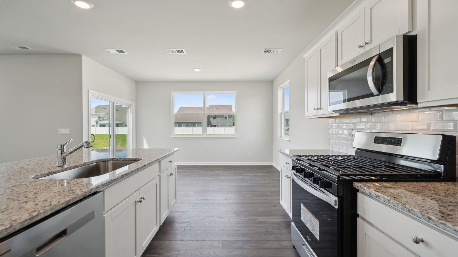 Sleek kitchen design with new appliances, Pantry, cabinet options and island breakfast bar in Arbors at Farms of New Kent