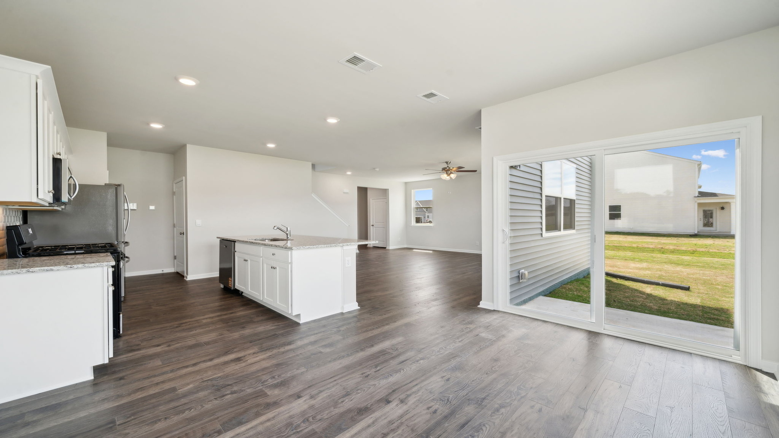 View from dining room into kitchen with island, pantry, new appliances and cabinet options at Arbors at Farms of New Kent