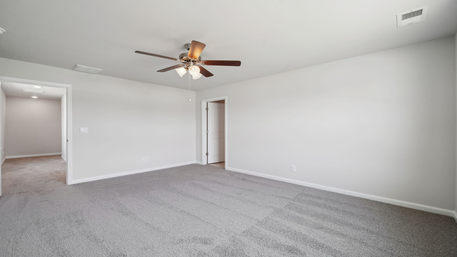 Bright and open owner's bedroom in Arbors at Farms of New Kent overlooking the backyard, en-suite bathroom, Walk-in closet.