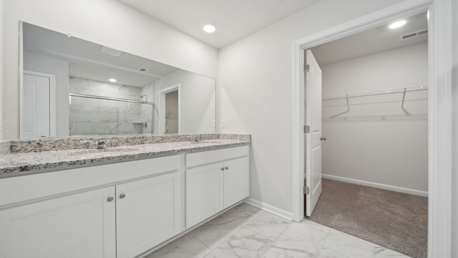 Owner’s en-suite new build home offers a functional layout with a walk-in closet, and spa-like en-suite shower-bath designs