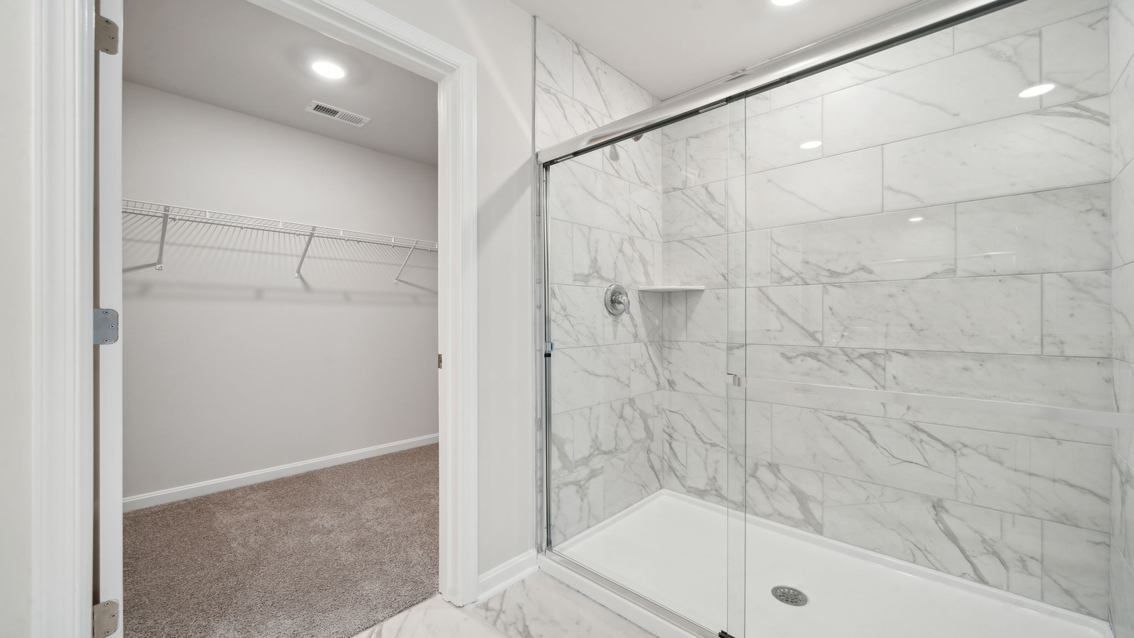 Owner’s en-suite new build home offers a functional layout with a walk-in closet, and spa-like en-suite shower-bath designs