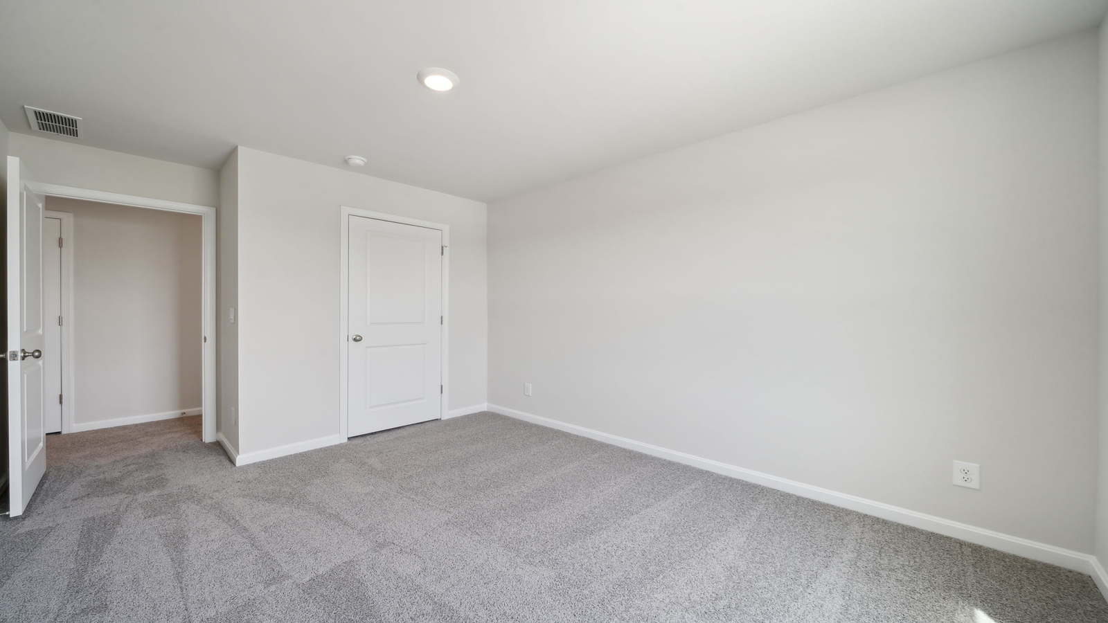 Spacious primary bedroom in New Construction Home by D.R. Horton includes Modern Design finishes and quiet rear-facing windows.
