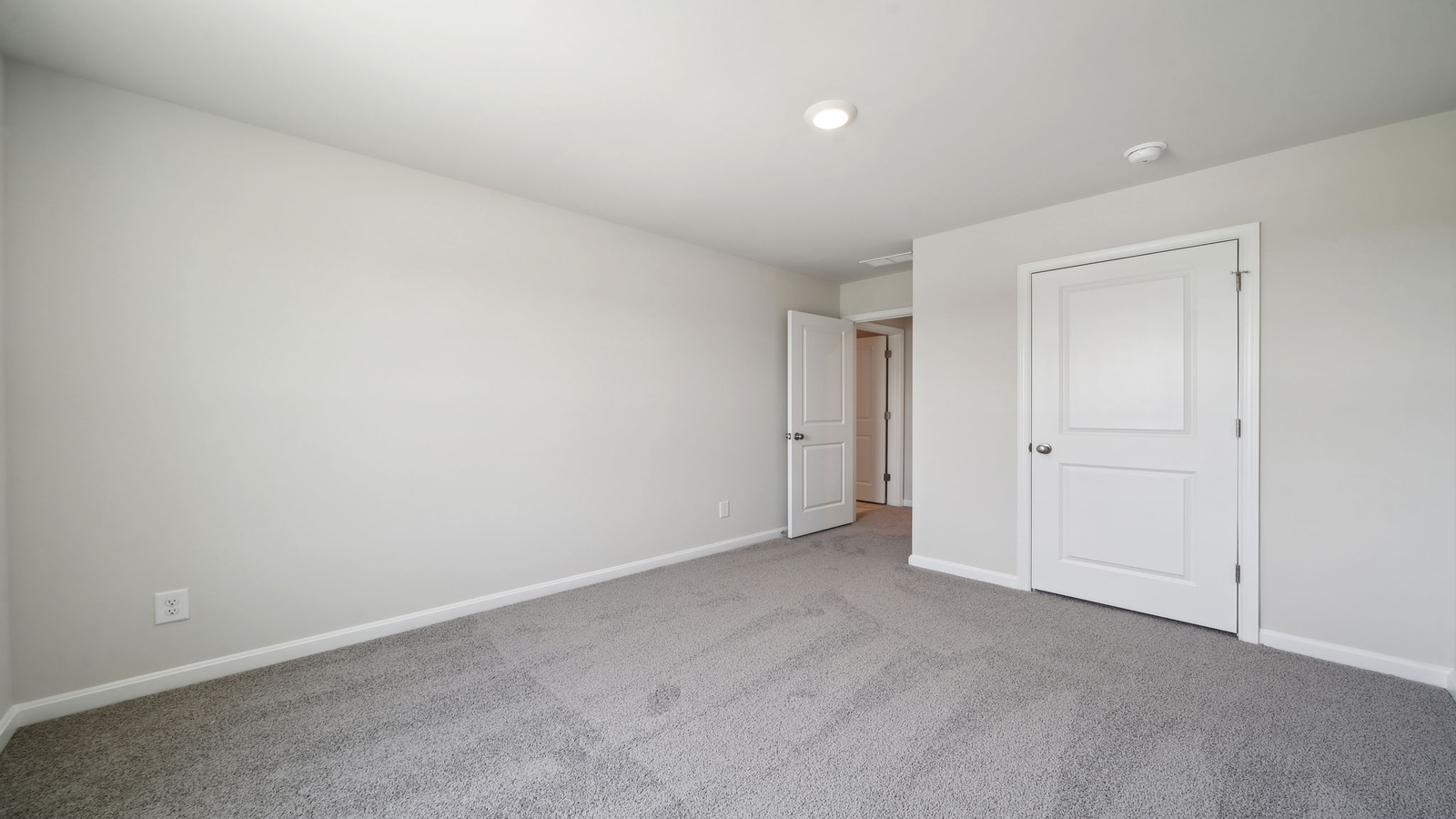 Primary suite at Arbors at Farms of New Kent corner window views, walk-through access to en suite bathroom, walk-in closet