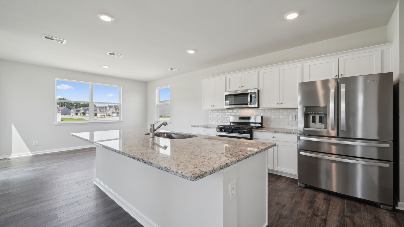 Spacious kitchen with island, pantry, dining and family area, and brand-new appliances throughout in Arbors at Farms of New Kent