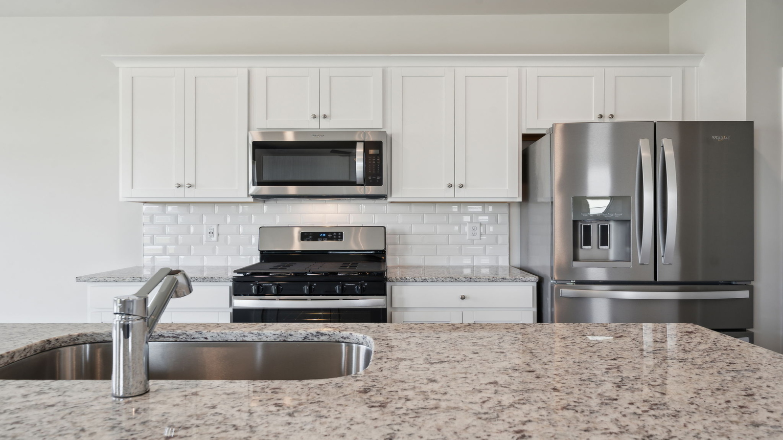 Bright kitchen with center island, Pantry, hard surface countertops, brand-new appliances in Arbors at Farms of New Kent