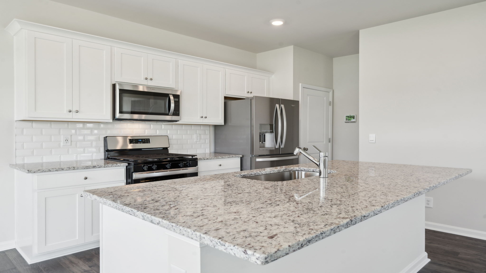 Open floor plan featuring kitchen island and Great Family-Living spaces in Arbors at Farms of New Kent