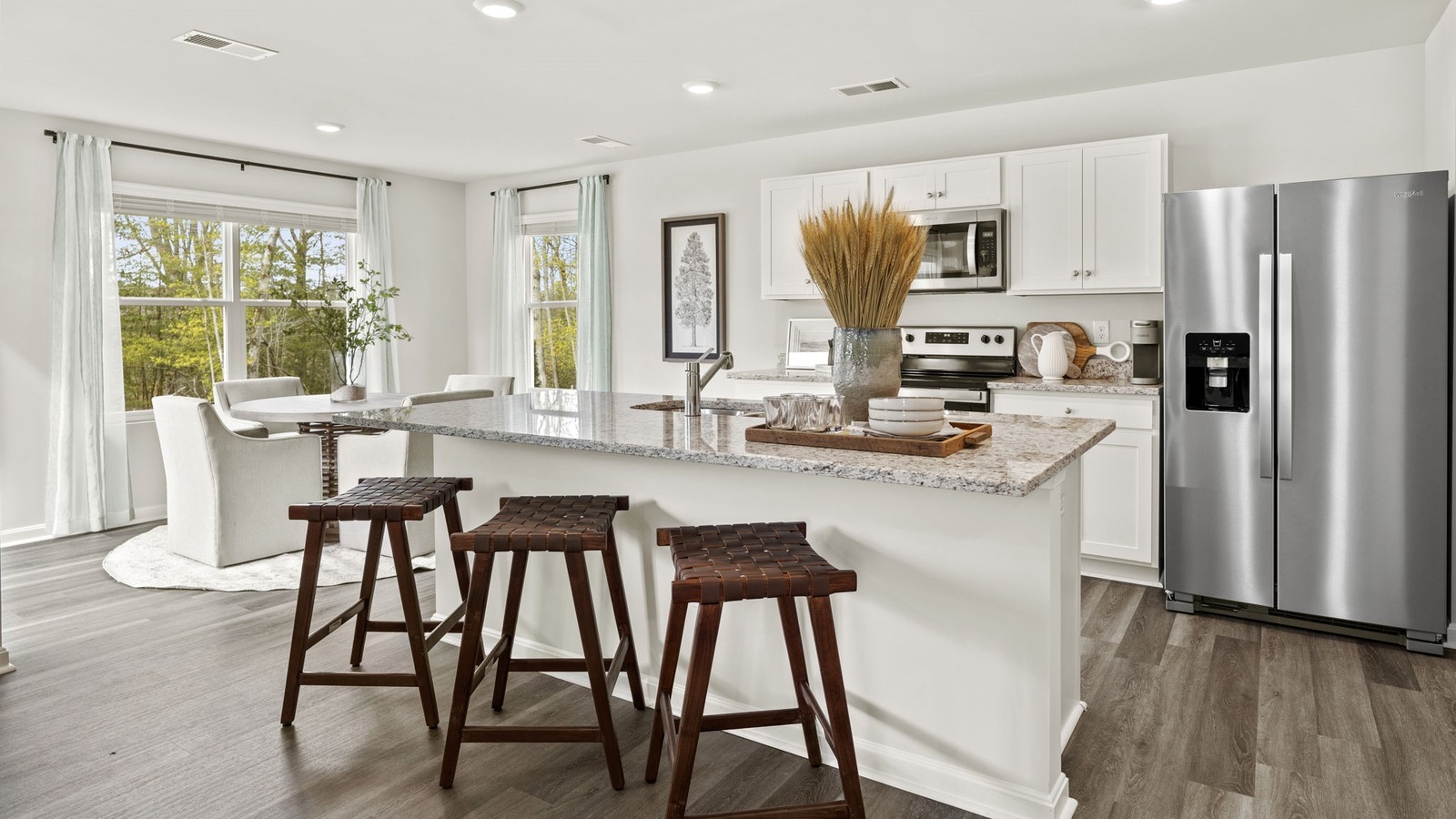 This new home features an open-concept kitchen with pantry, a central island, spacious cabinet options, and new appliance suite