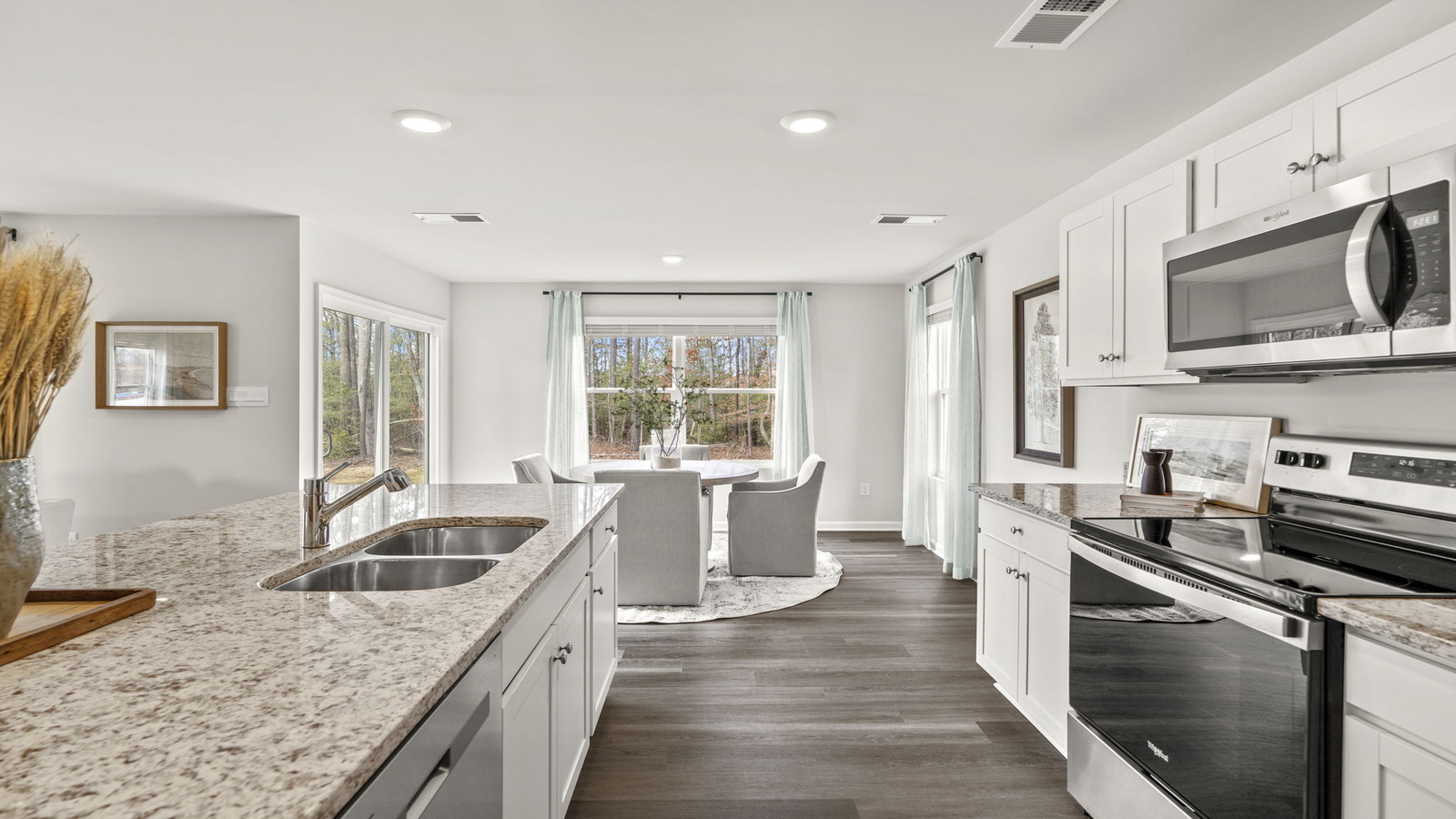 The kitchen features a large island with seating, pantry, New appliance suite, and Modern Design finishes near dining, living