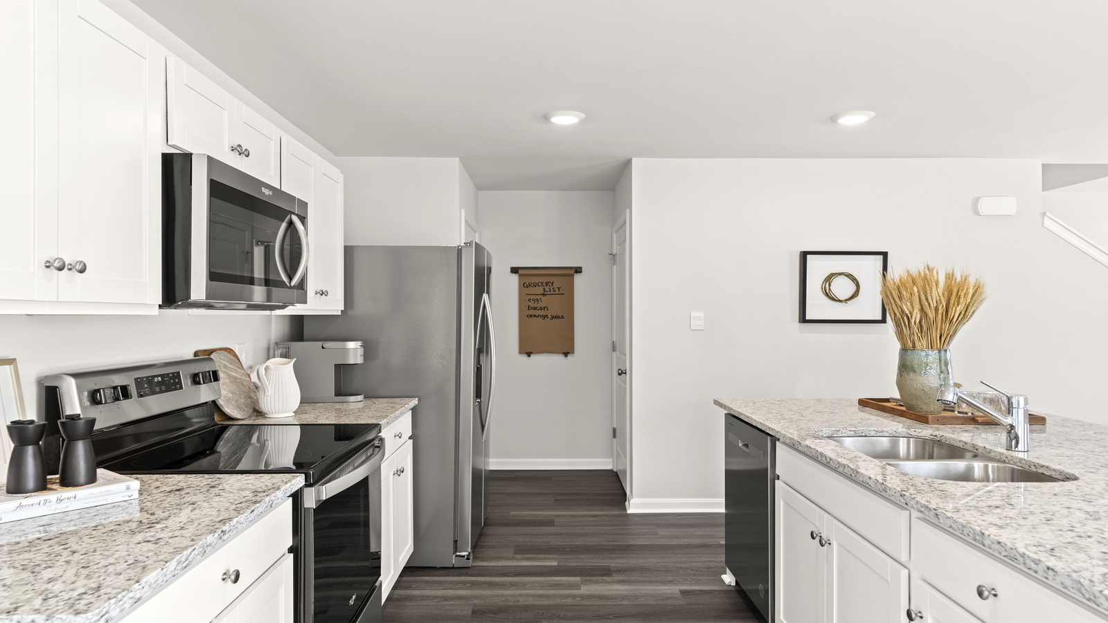 Sleek kitchen design with new appliances, Pantry, cabinet options and island breakfast bar in Arbors at Farms of New Kent