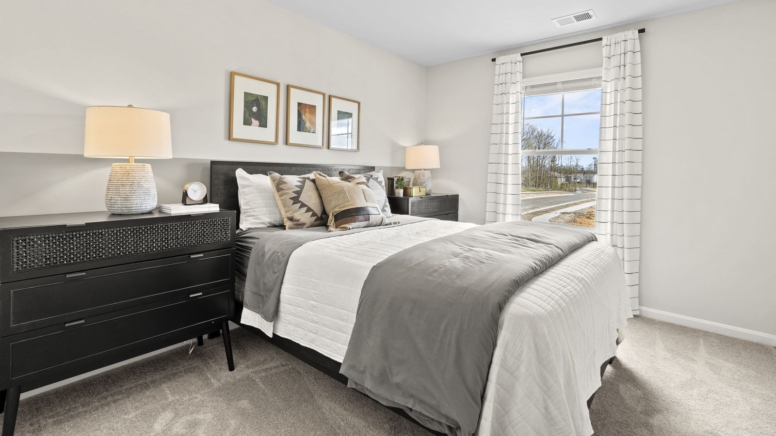 Secondary Bedroom in Arbors at Farms of New Kent showcases quality flooring, closet space, soft window light, and convenient home access