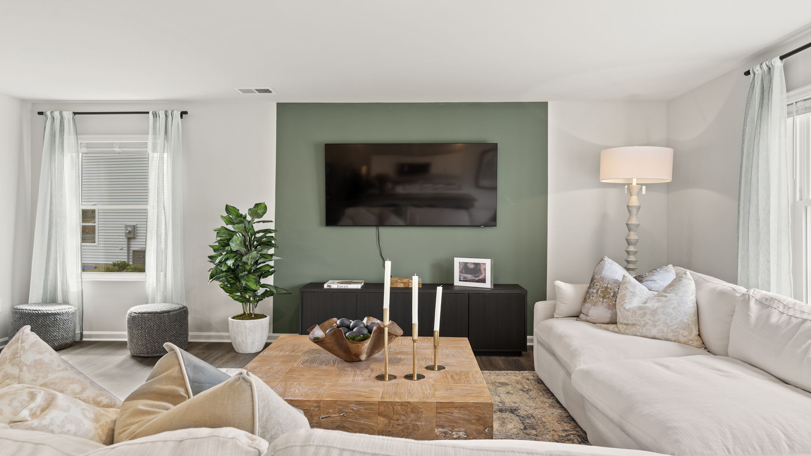 Living room with modern design accents, front views, and convenient traffic flow throughout Arbors at Farms of New Kent