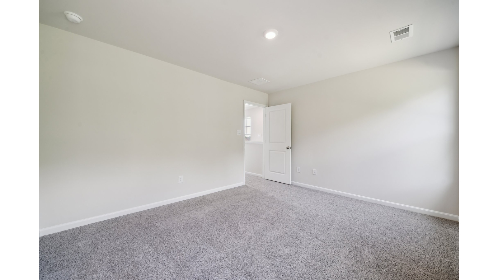 Primary suite at Arbors at Farms of New Kent corner window views, walk-through access to en suite bathroom, walk-in closet