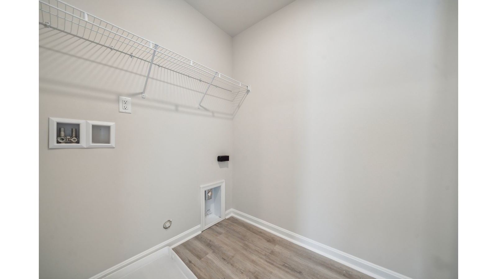 Functional D.R. Horton utility laundry room in Arbors at Farms of New Kent  featuring elevated storage for convenience