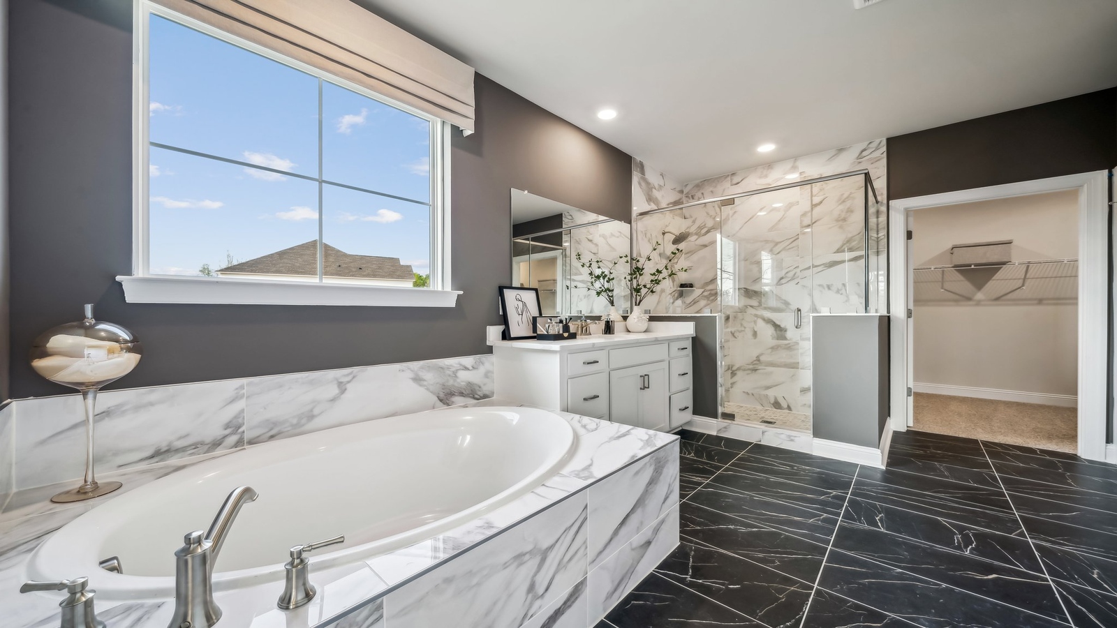 Owner’s ensuite in a new build home offers function with a walk-in closet, spa-like ensuite, stylish walk-in closet