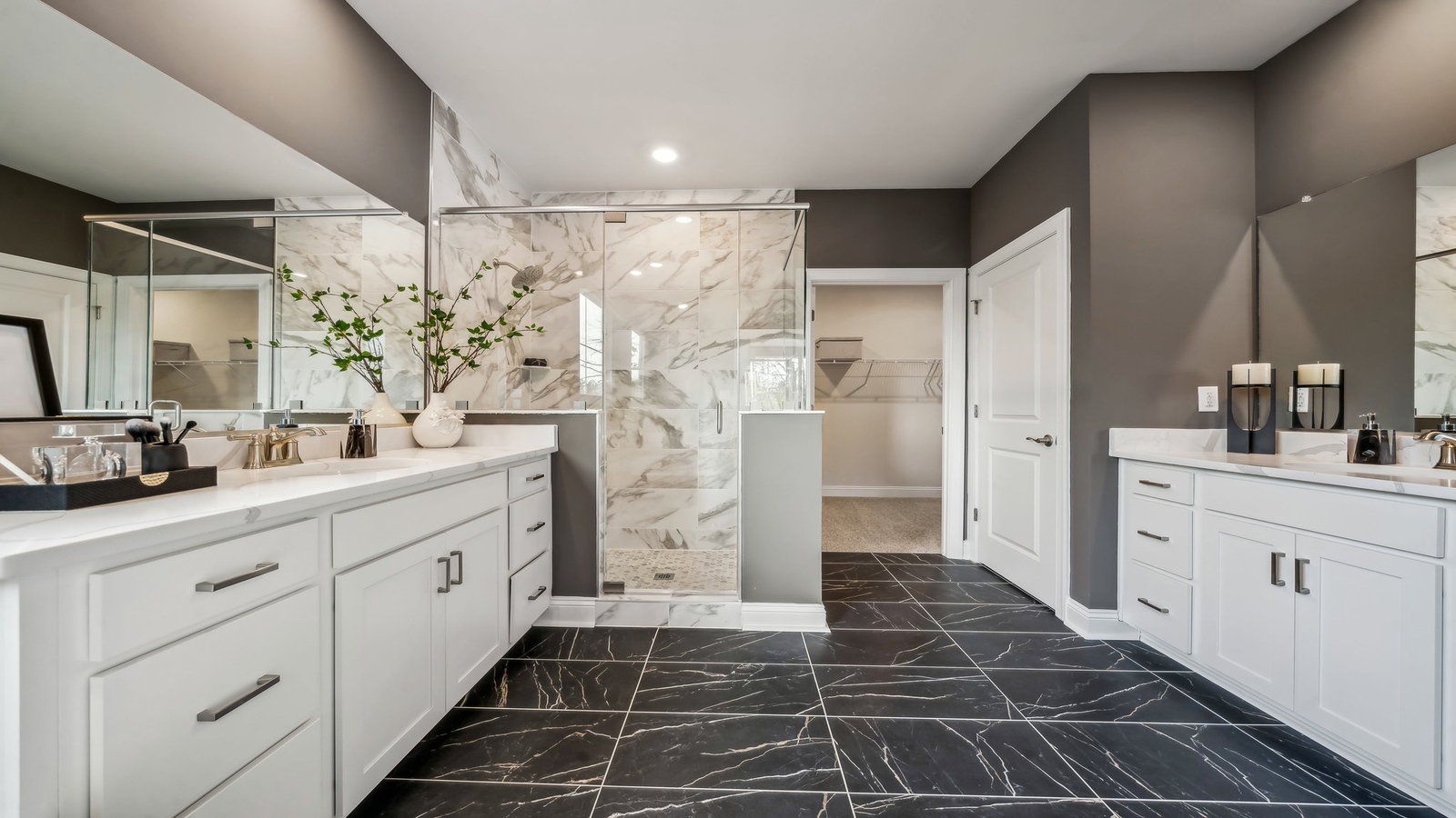 Primary ensuite bathroom in D.R. Horton's new home featuring an expansive vanity with dual sinks, shower, tub, walk-in closet