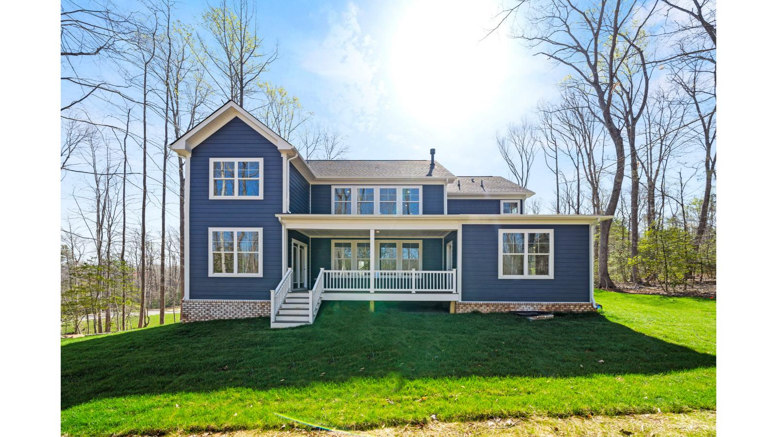 Backyard with covered deck offering room for seating, grill setup, and a transition from indoor to outdoor living