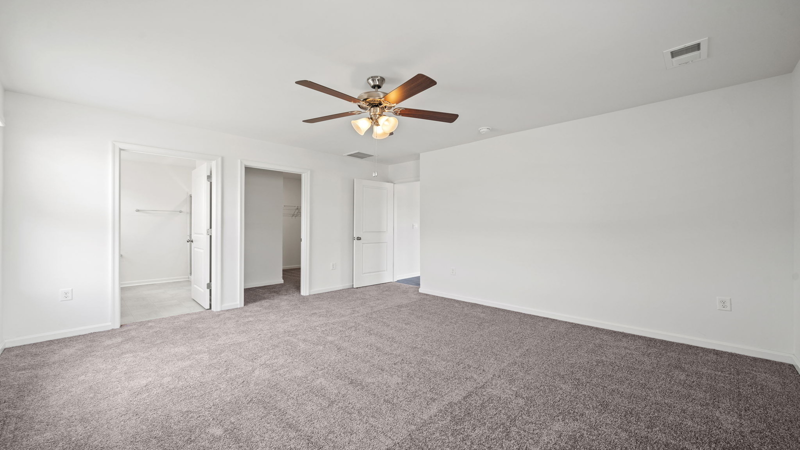 Bright and open primary bedroom in Chappell Creek with walk-in closet, stylish ensuite bath, overlooking backyard