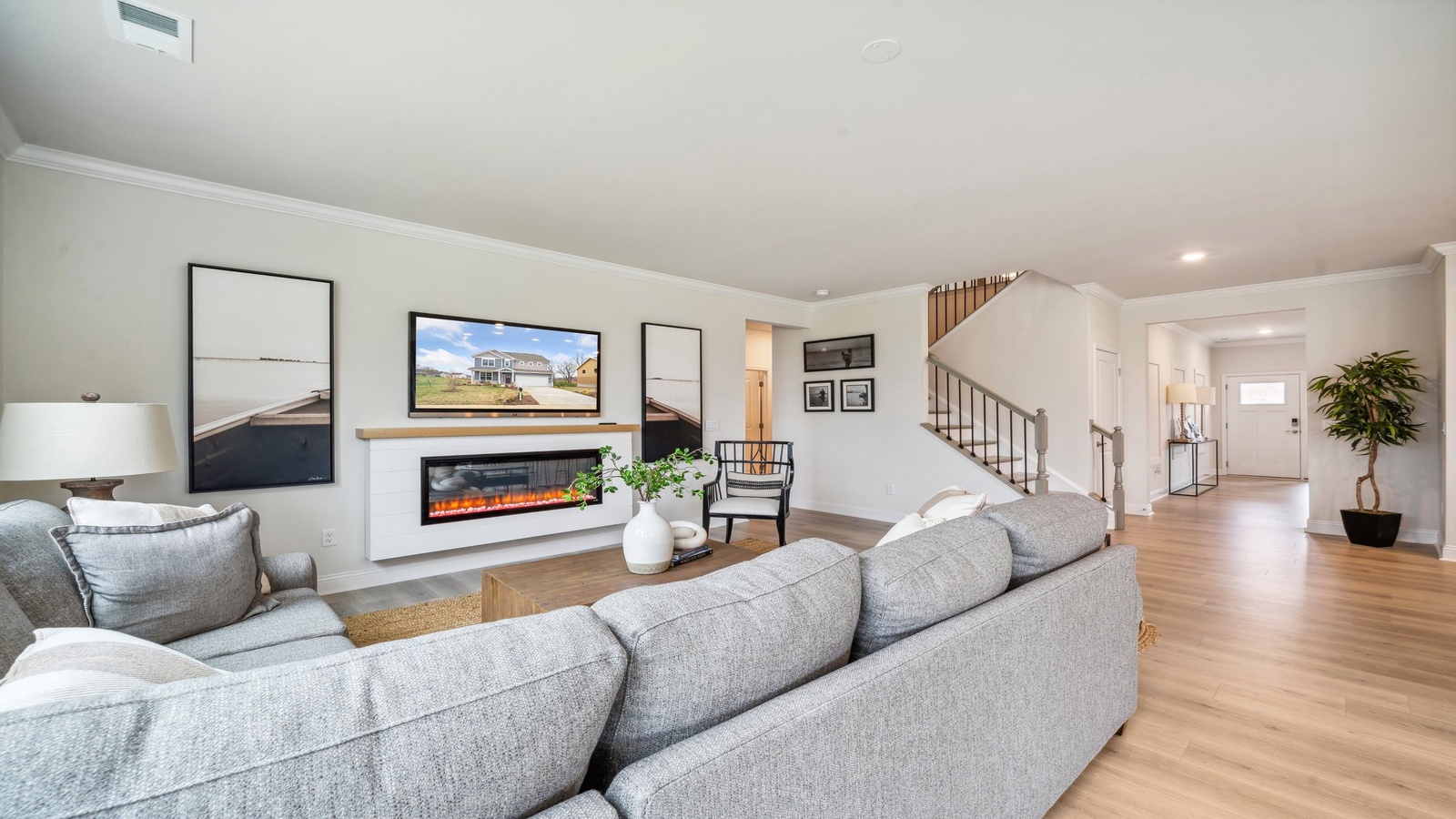Connected main living area at Copper Grove at Harpers Mill emphasizing openness between kitchen, dining, and great room