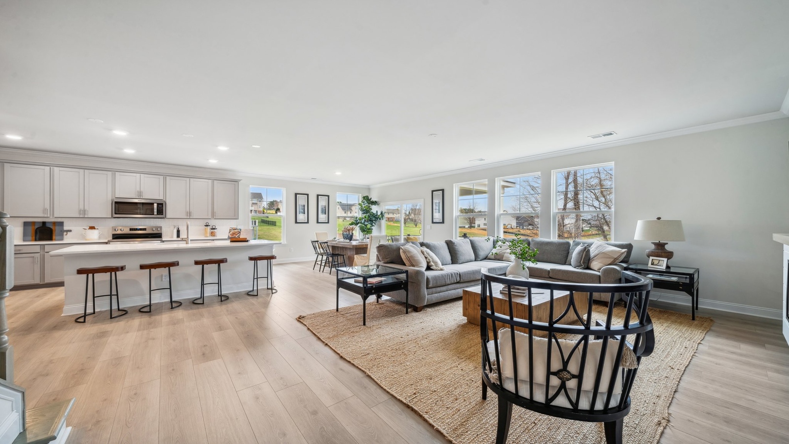 Kitchen, dining, and living areas form one flowing main living space designed for comfort, simplicity at Copper Grove at Harpers Mill