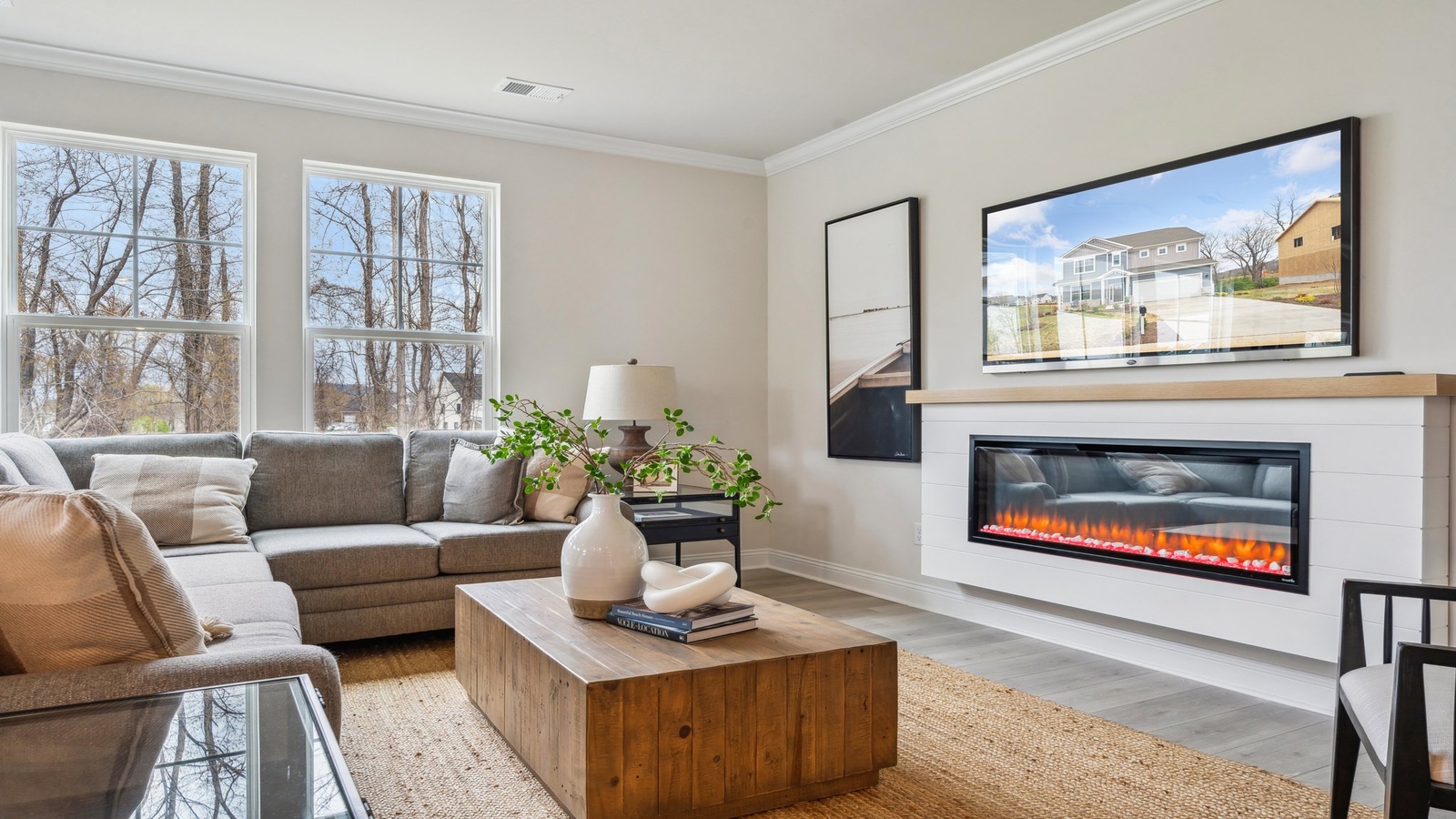 Main living space at Copper Grove at Harpers Mill offering natural light and open layout between kitchen, dining, and living room
