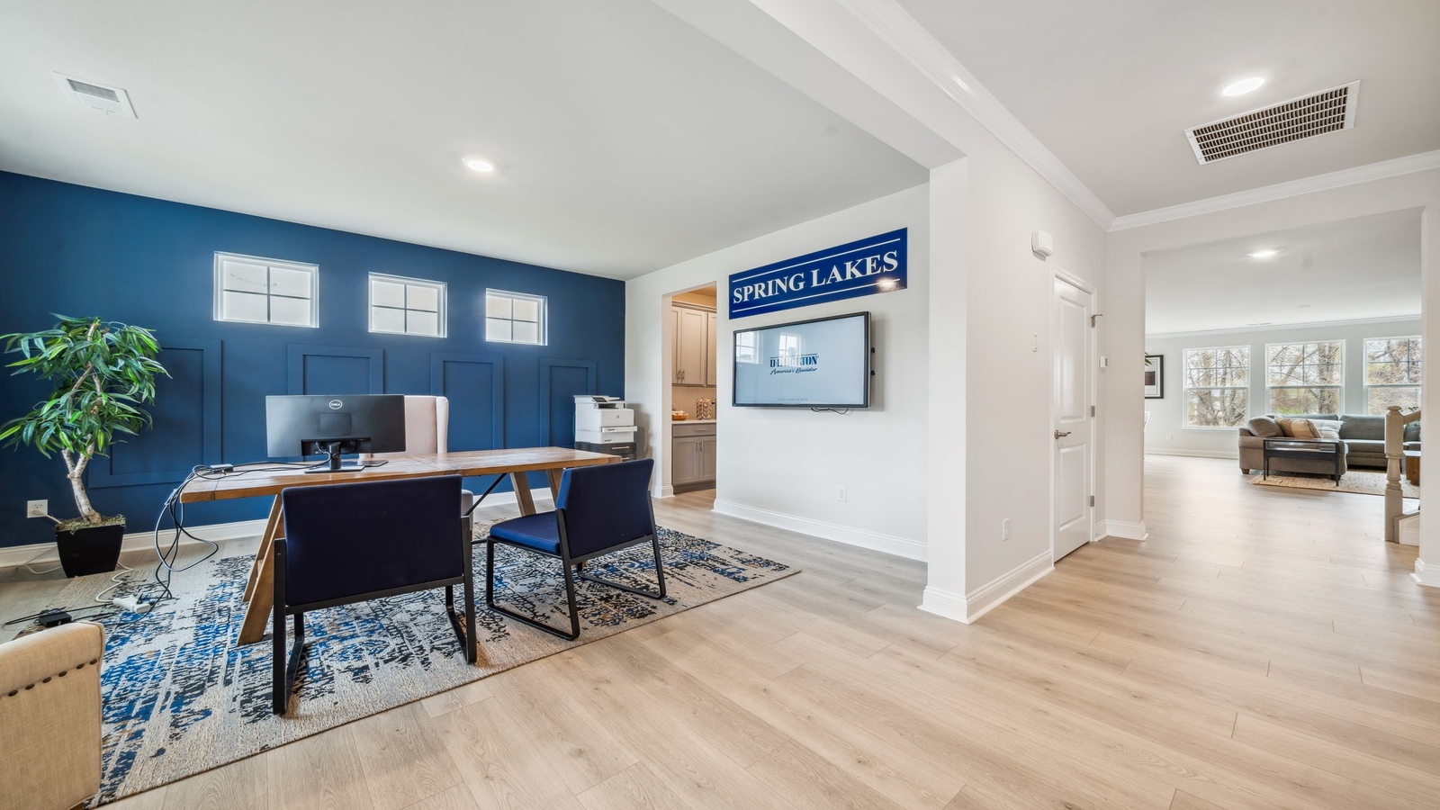 Great room with stylish flooring, connected kitchen with stairwell view at Copper Grove at Harpers Mill
