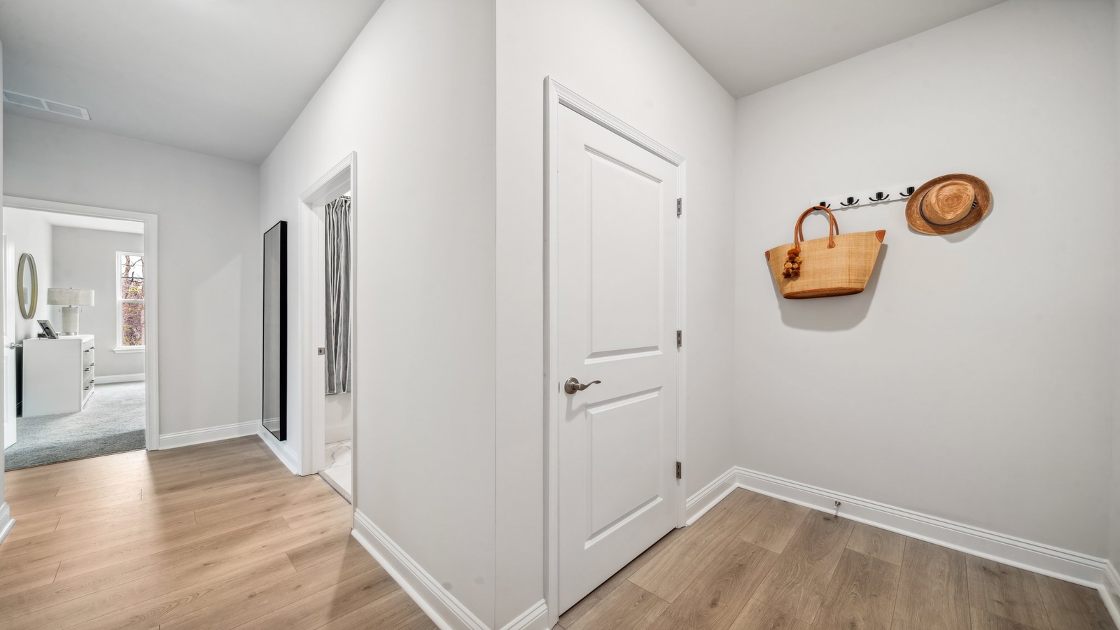 Copper Grove at Harpers Mill  front foyer with sleek tile flooring and open access to nearby rooms