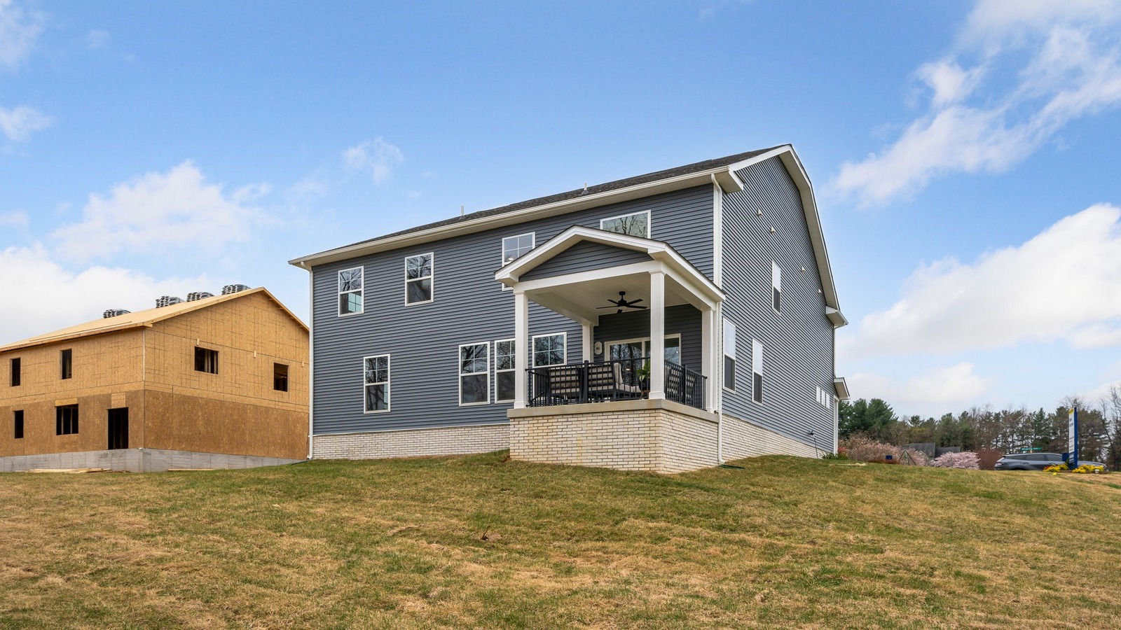 Backyard in this New Home with full lawn, covered patio slab, and fencing potential for added privacy