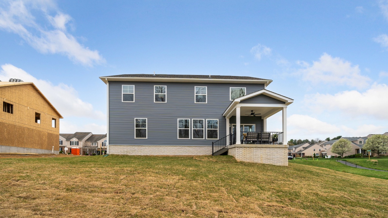 Rear covered patio connected to dining nook and family room offering outdoor access in this New Construction Home