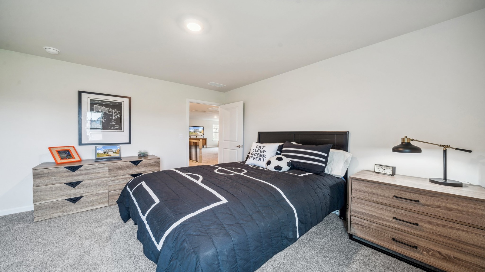Secondary Bedroom in this home showcases space via single door closet, window and convenient home access Copper Grove at Harpers Mill