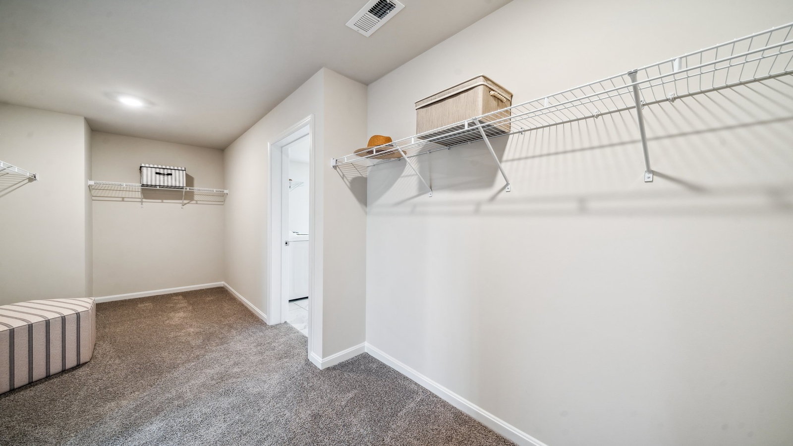 Walk-in closet directly off the primary suite in Copper Grove at Harpers Mill designed for modern living