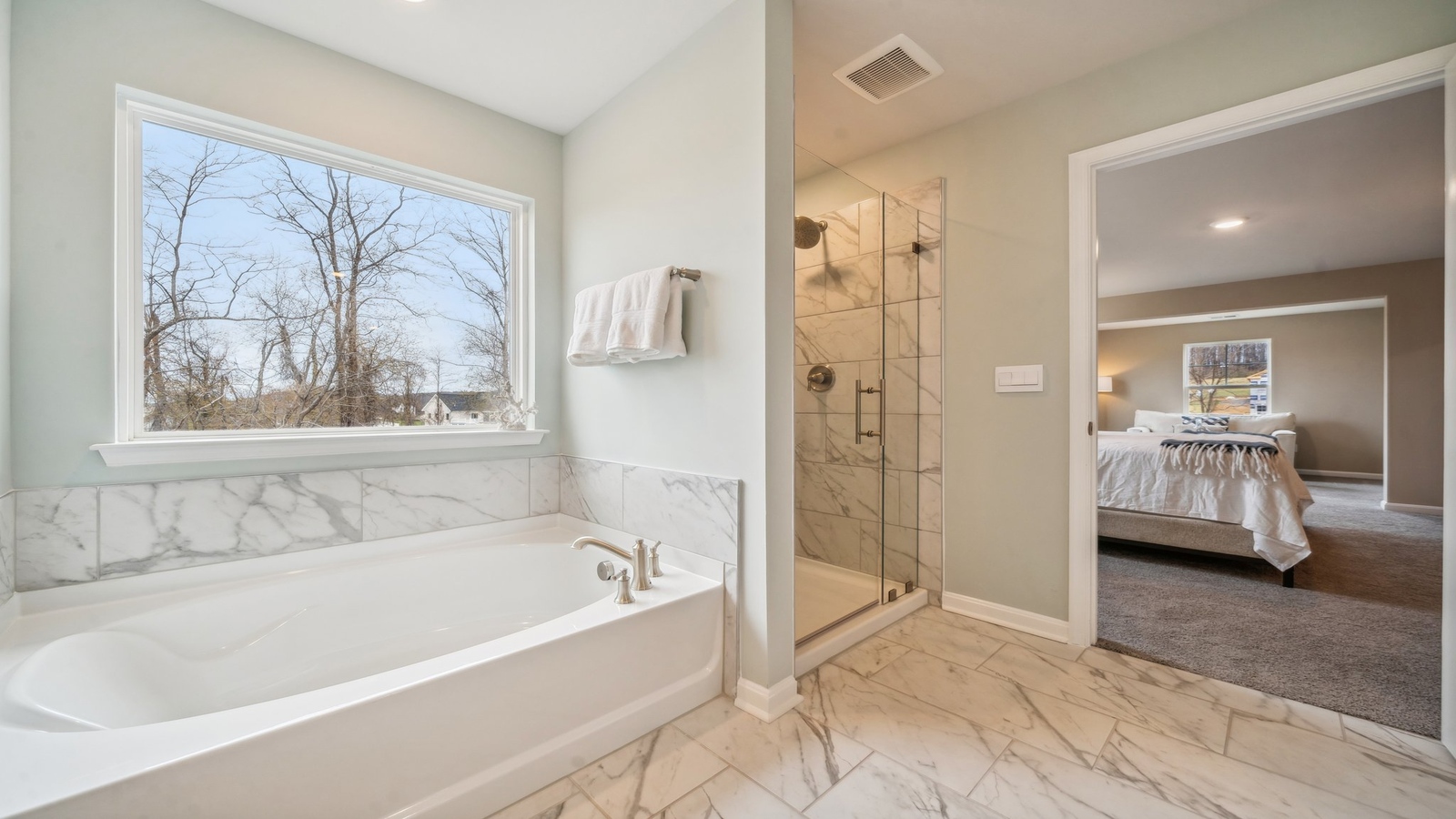New Home showcases a D.R. Horton en suite bathroom with sleek flooring, open layout to shower-tub, and walk-in closet