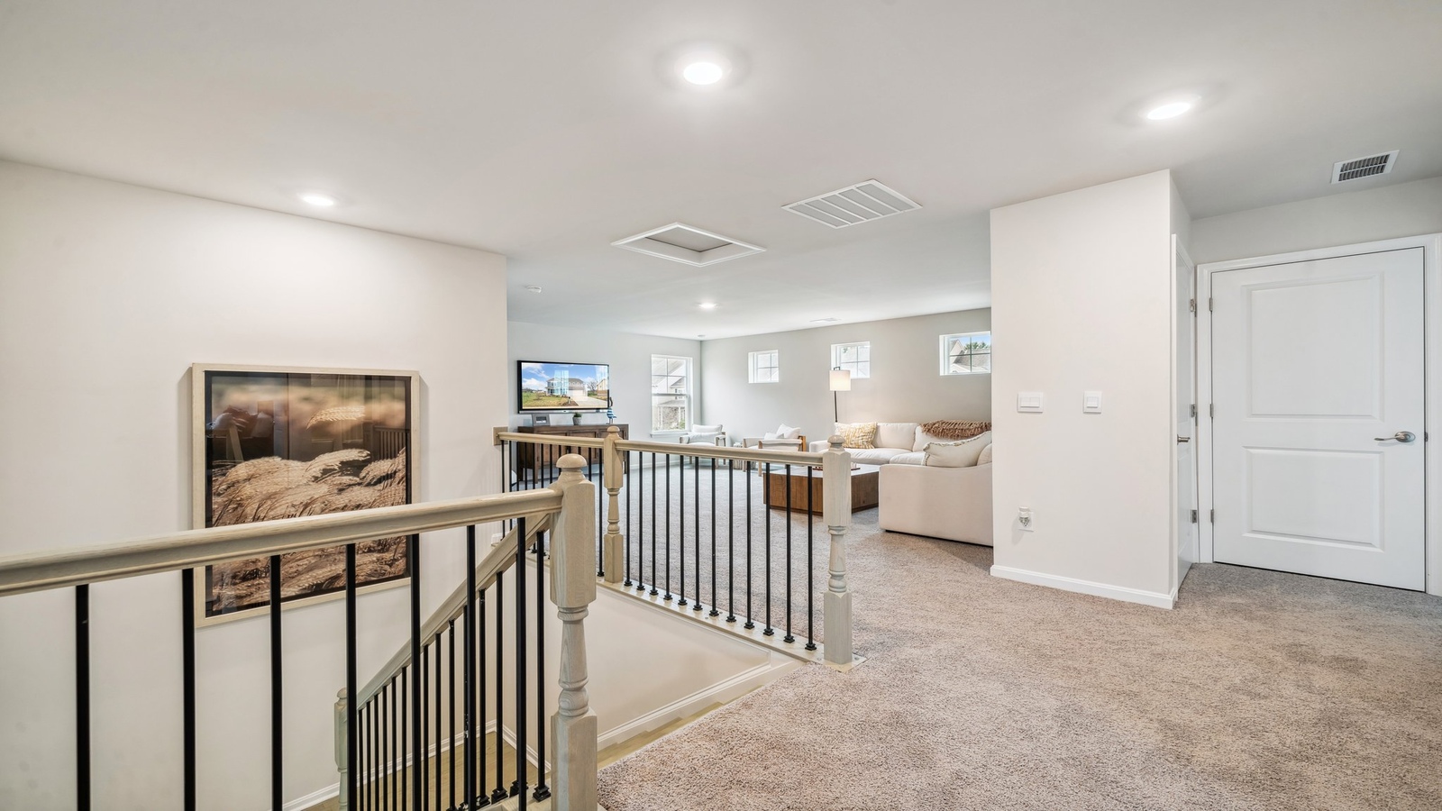 Loft + Secondary Bedroom Modern upstairs configuration features living and sleeping areas for remote work, study, or visitors in this New Home