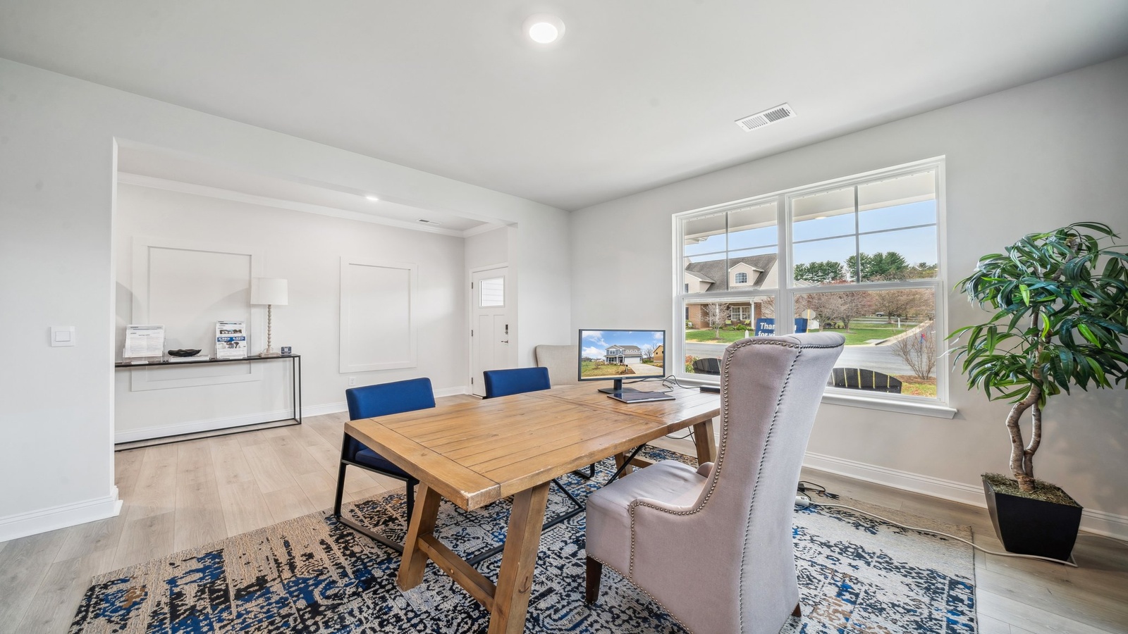 Open living space with direct view into kitchen featuring pantry, and new appliances at Copper Grove at Harpers Mill