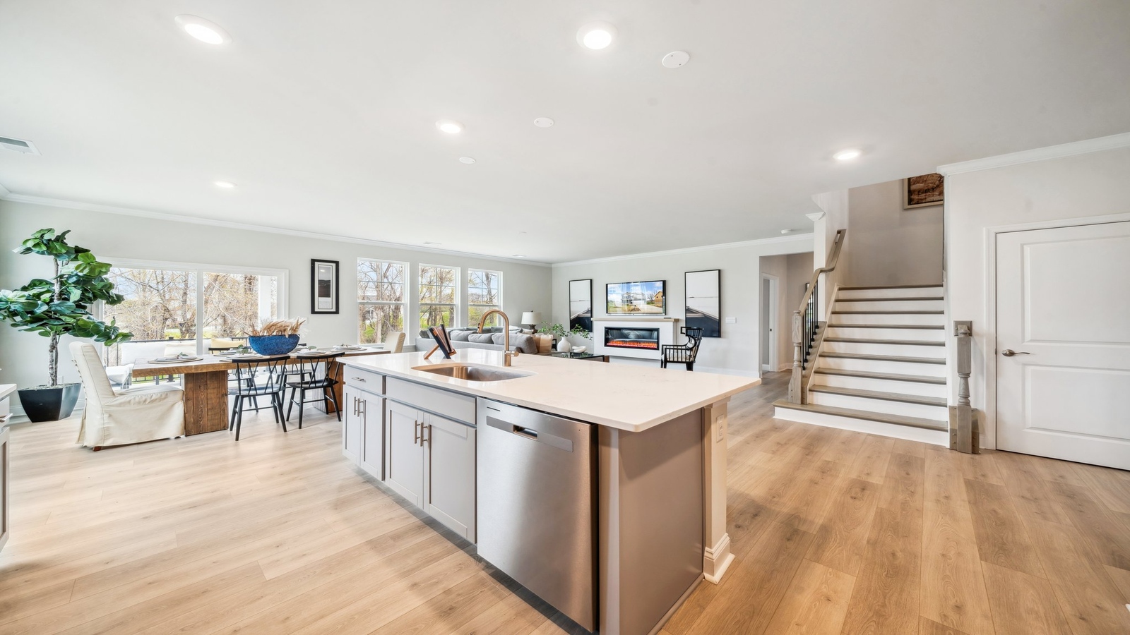 Kitchen island in this New Home includes seamless integration with dining area and Open Concept floorplan