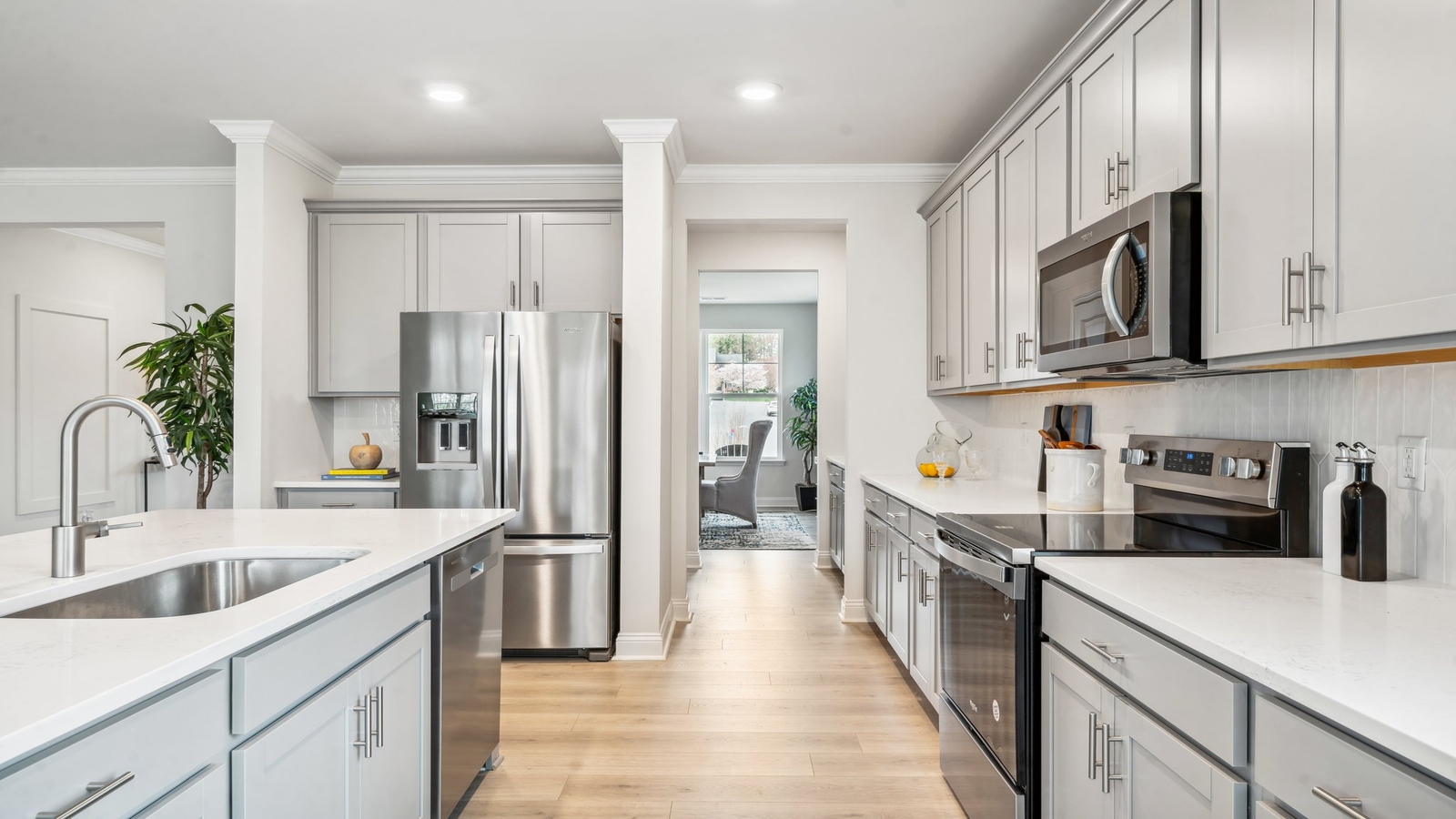 Functional island in this New Construction House with hard surface countertops, cabinet storage, and New appliances
