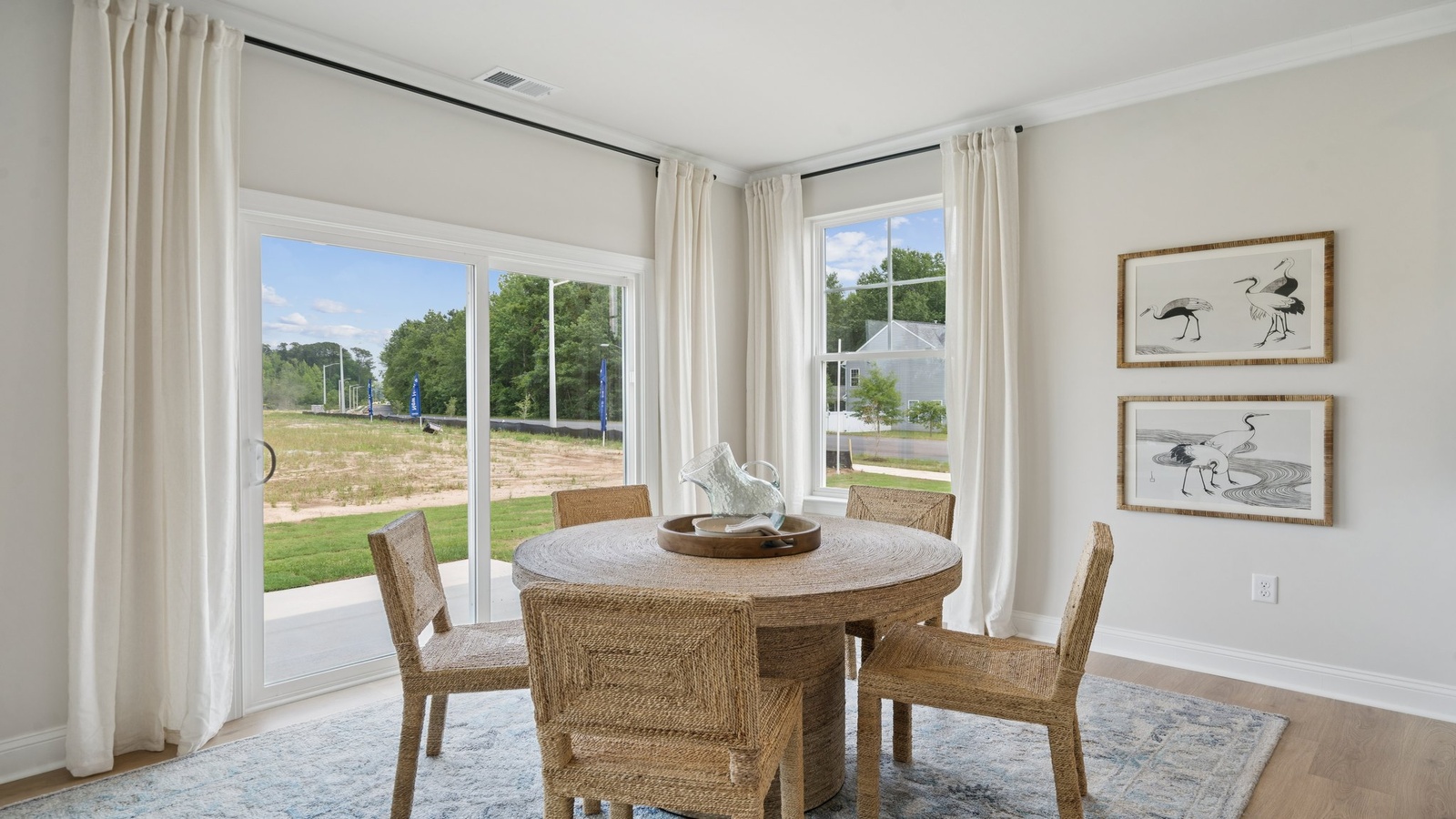 Dining room located at Copper Grove at Harpers Mill home adjacent to the main entryway