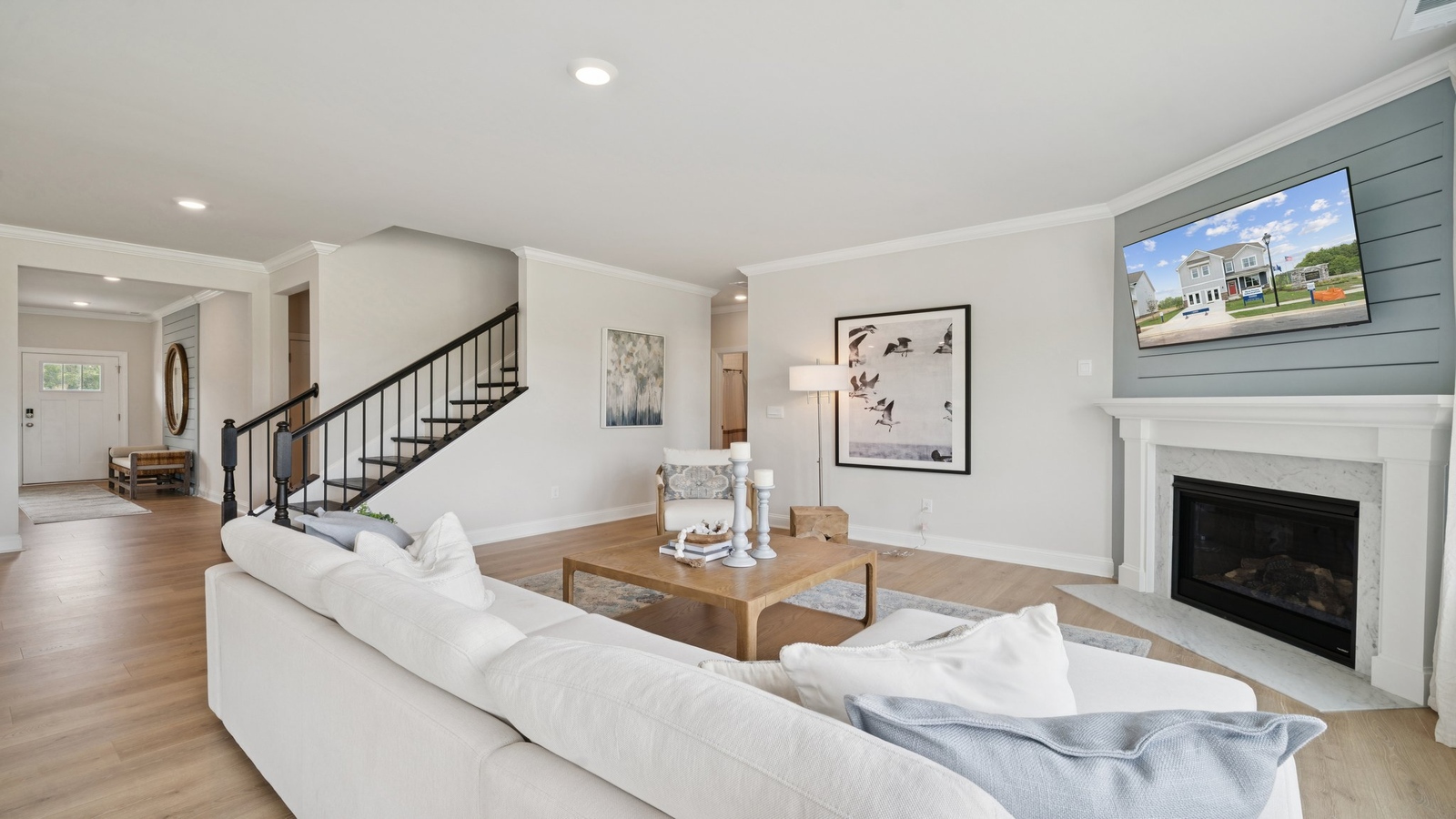 Main living zone with easy access near kitchen, dining area, and an electric fireplace in Copper Grove at Harpers Mill