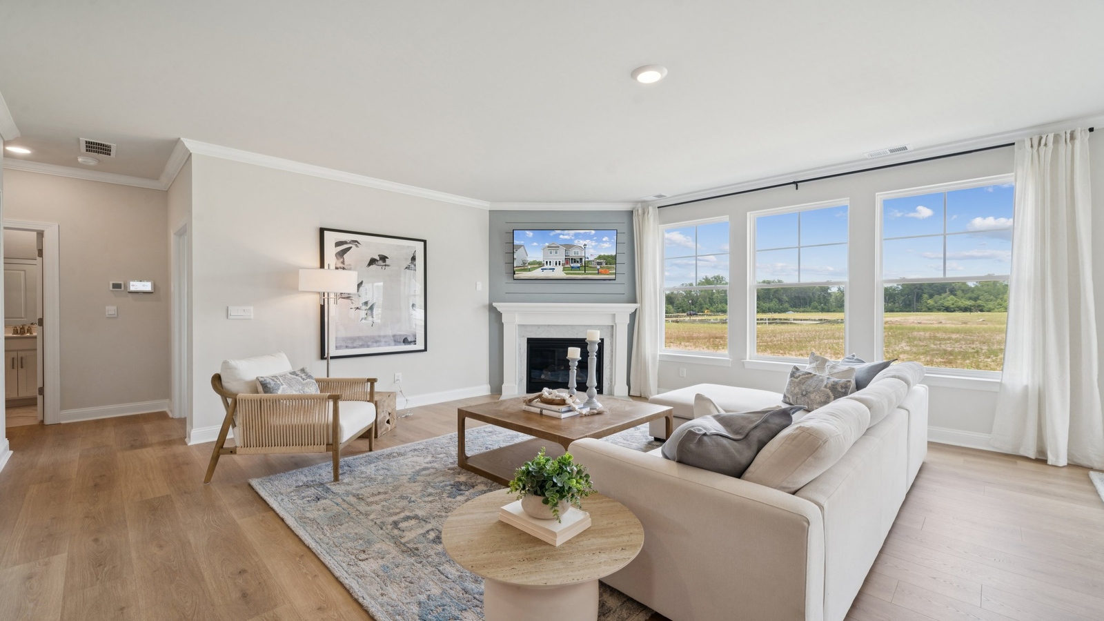 Main living space at Copper Grove at Harpers Mill combining kitchen, dining, and living room designed into one open concept