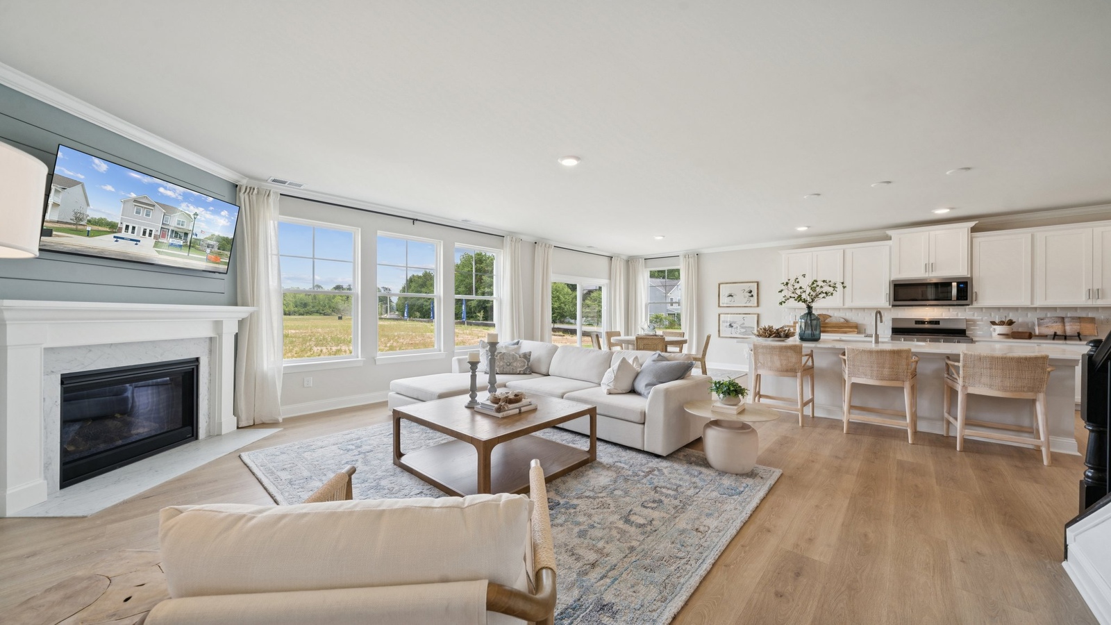 Kitchen, dining, and living areas form one flowing main living space designed for comfort and simplicity at Copper Grove at Harpers Mill