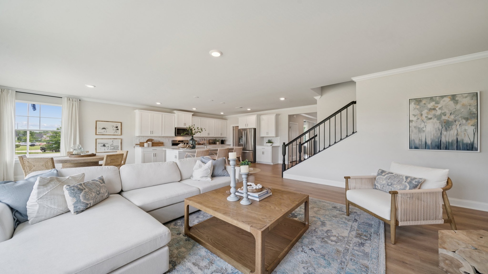 Main living zone with easy access between kitchen, dining area, and family room in Copper Grove at Harpers Mill