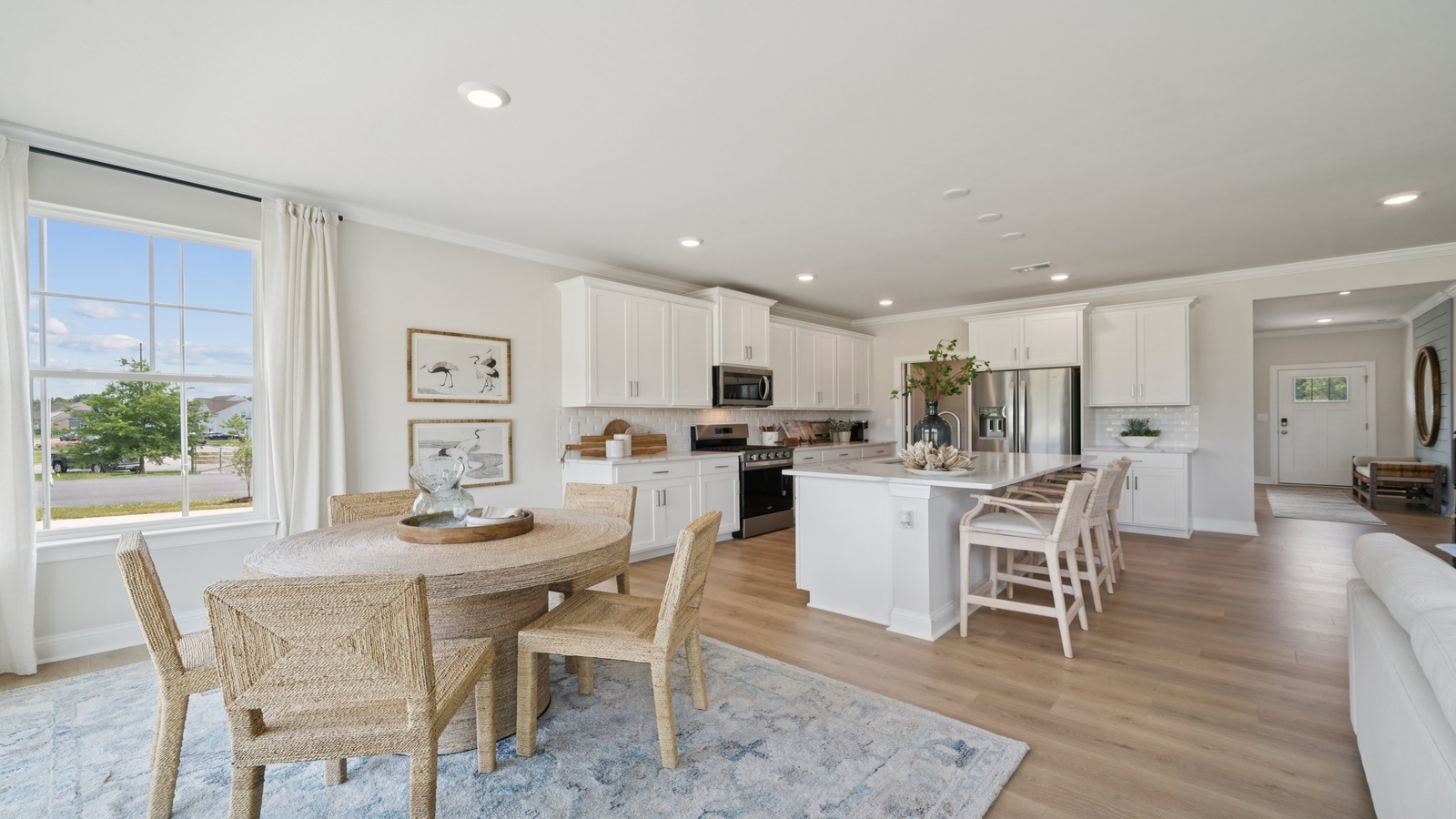 Copper Grove at Harpers Mill dining space with electric fireplace, unified kitchen, living room, in one practical main space