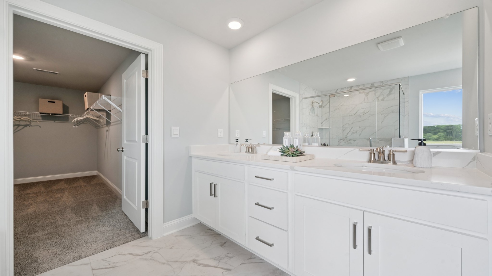 New Home showcases a D.R. Horton en suite bathroom with sleek flooring, open layout to shower-tub, and walk-in closet