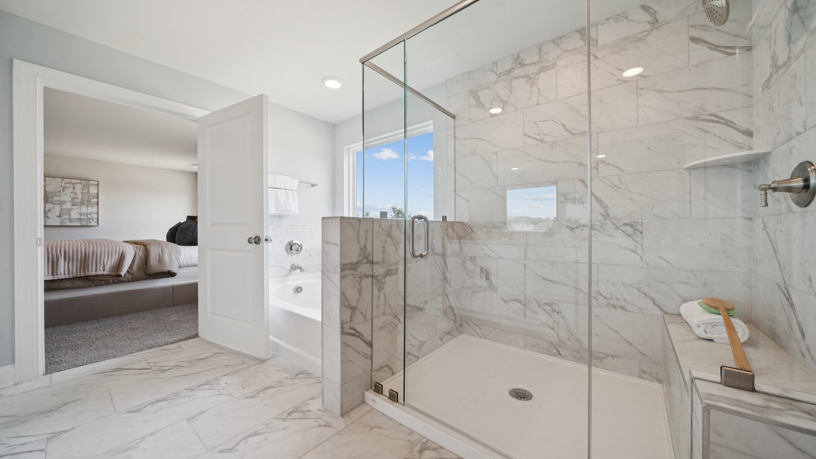 Spacious en-suite bathroom featuring excellent vanity with fixtures, stylish bath-shower finishes and walk-in closet access