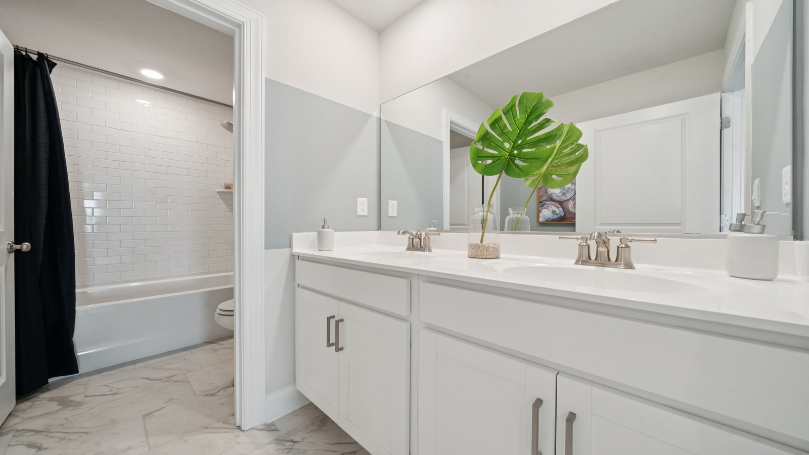 New Home showcases a D.R. Horton en suite bathroom with sleek flooring, open layout to shower-tub, and walk-in closet