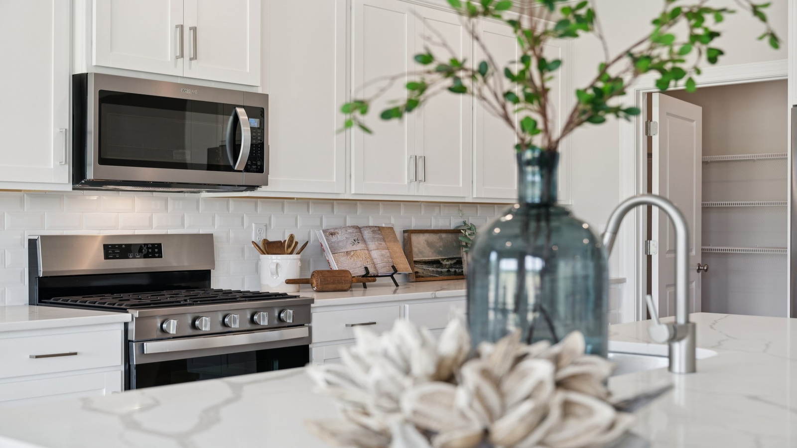 Our Kitchen includes an island with seating, a pantry, meal prep zones, and casual dining, and New appliance suite