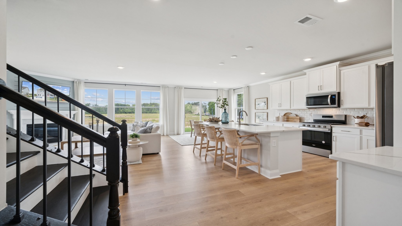 Modern kitchen in this New Home showcases an oversized island with bar seating, pantry and smart new appliance suite.