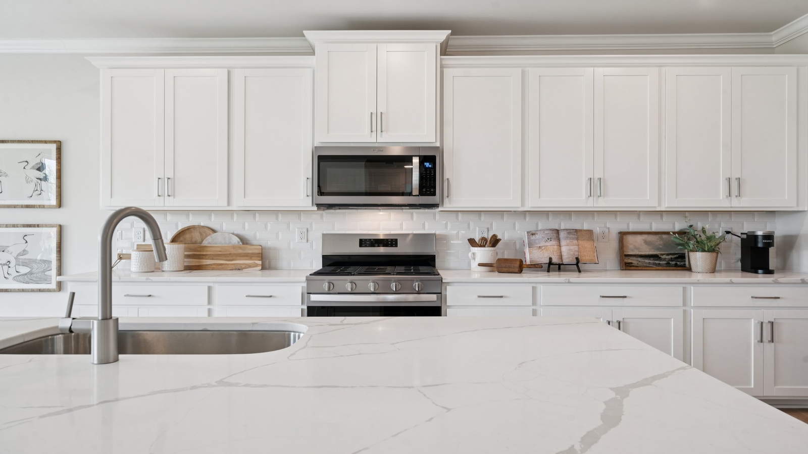 Kitchen island in this New Home includes seamless integration with dining area and Open Concept floorplan