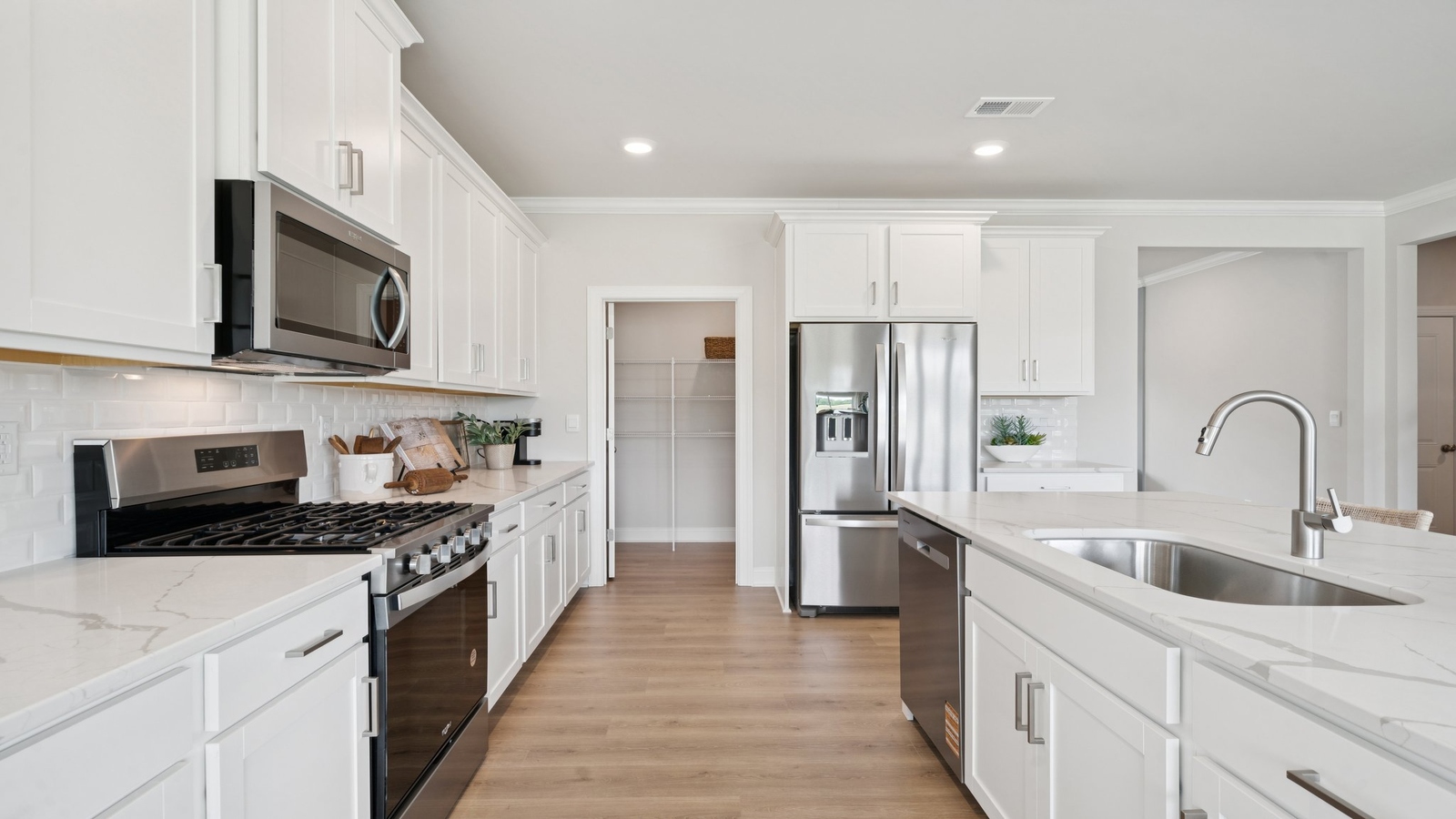 Spacious kitchen in this features a bright layout, pantry, kitchen island with seating, and full new appliance package.